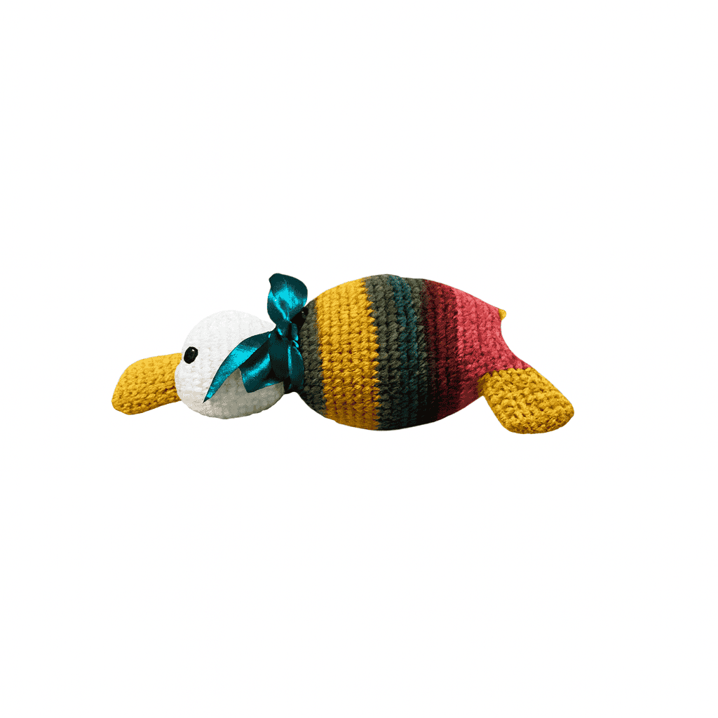 Colorful toy duck with a green ribbon