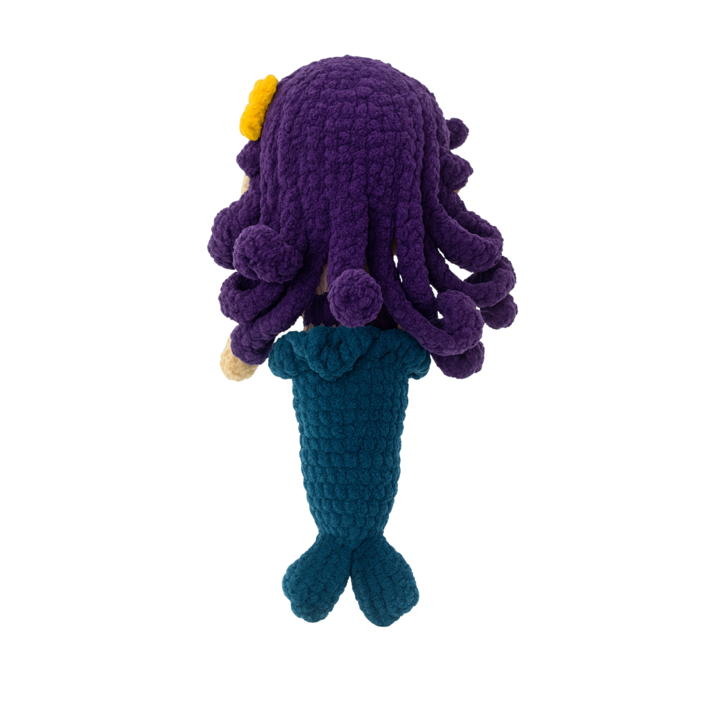 Crocheted Marina the mermaid toy with purple hair, purple top, and blue tail