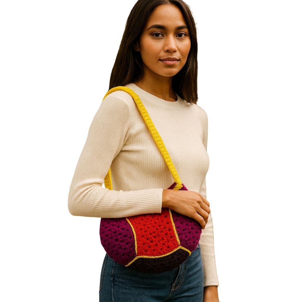 Woman holding a crocheted lava punch bag with a yellow handle
