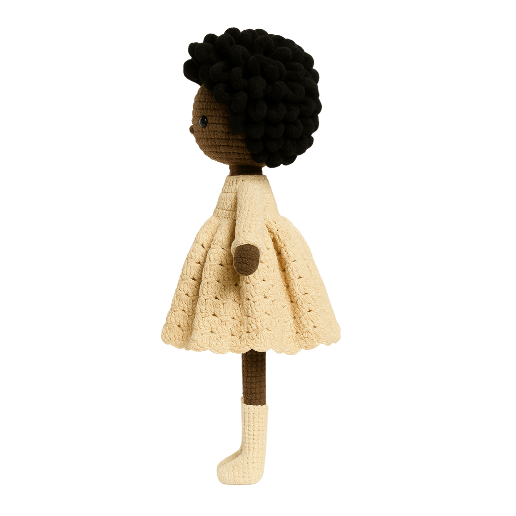 Knitted doll with black hair wearing a beige dress