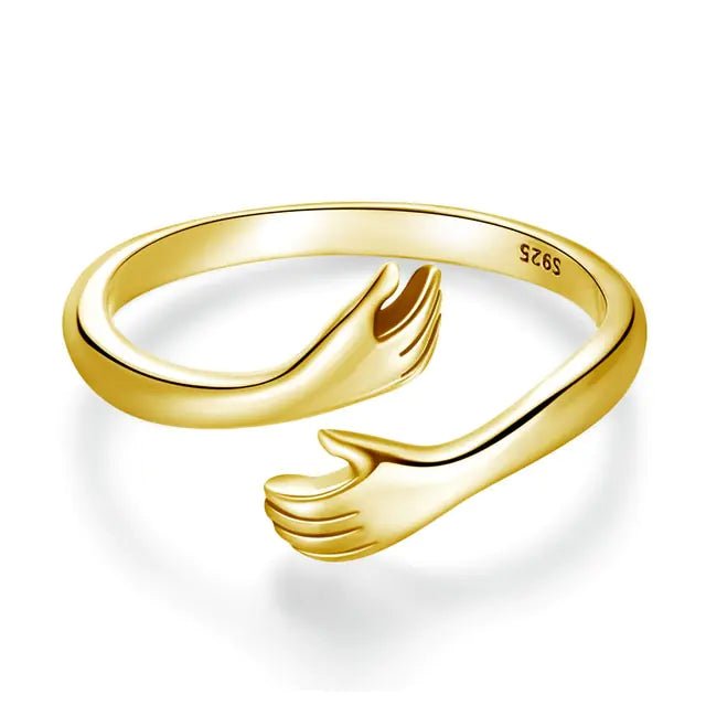 A 18K gold-plated sterling silver ring with an open design resembling an embrace.