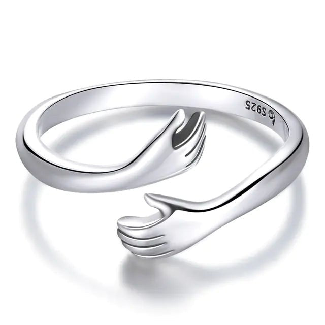 A 925 sterling silver ring with an open design resembling an embrace.