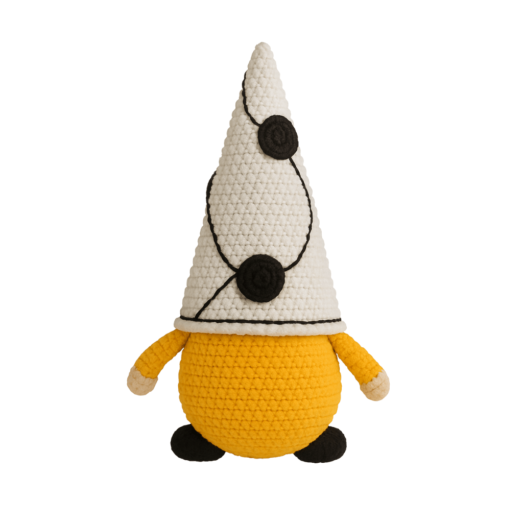 A handcrafted crochet gnome with a tall white hat with black dots, a mustard yellow body, and a black beard