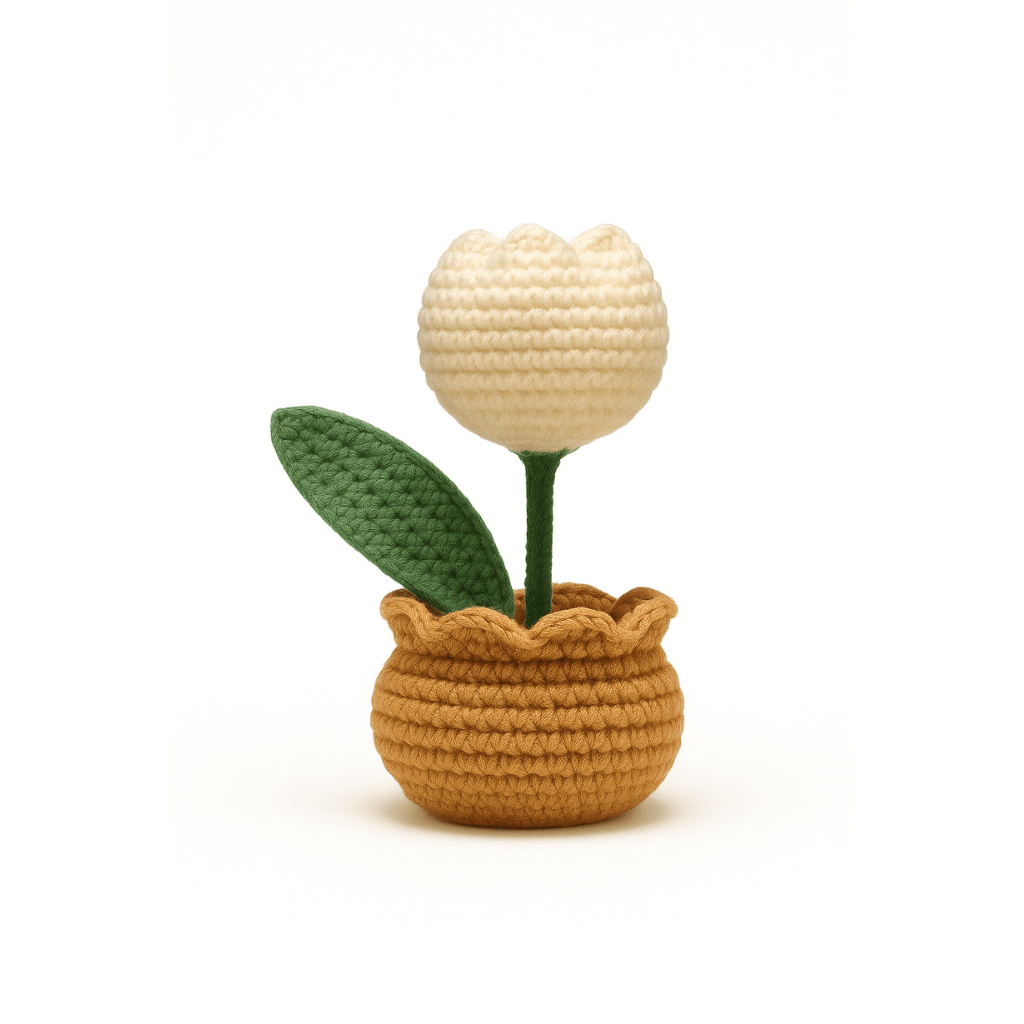 Crocheted potted plant with a beige flower and green leaves