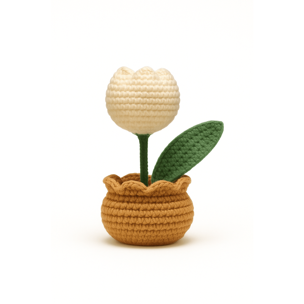Crocheted potted plant with a beige flower and green leaves