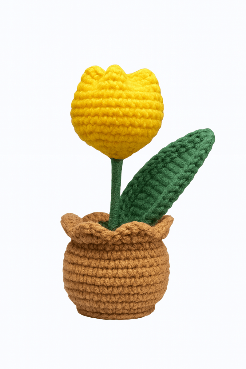 Crocheted yellow tulip in a brown pot with a green leaf