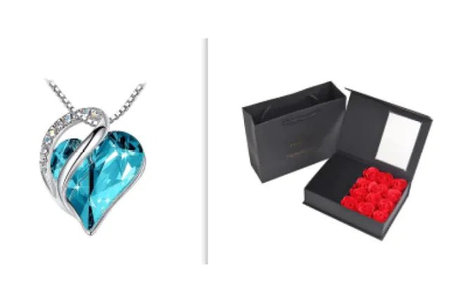 A set of a heart-shaped pendant necklace with a Turquoise crystal pendant surrounded by smaller clear crystal and a box.