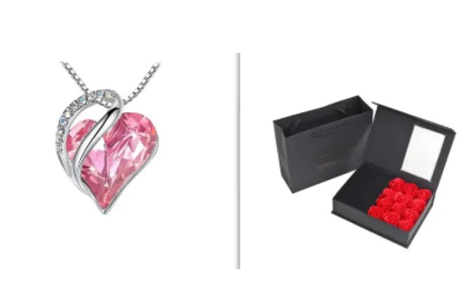 A set of a heart-shaped pendant necklace with a Light Pink crystal pendant surrounded by smaller clear crystal and a box.