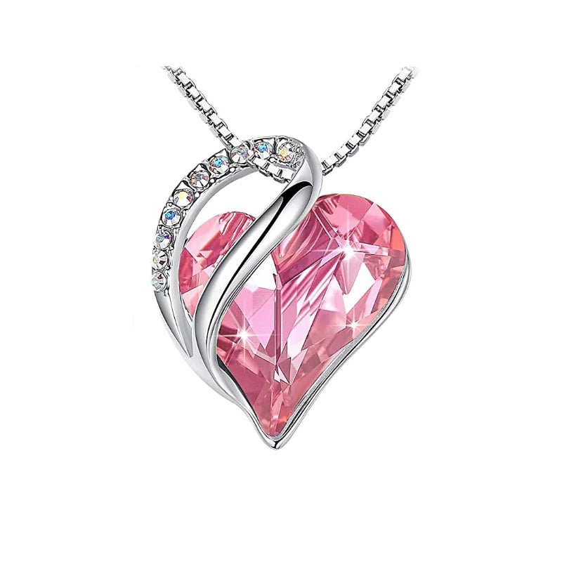 A heart-shaped pendant necklace with a Light Pink crystal pendant surrounded by smaller clear crystal.