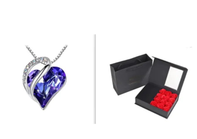 A set of a heart-shaped pendant necklace with a Royal Blue crystal pendant surrounded by smaller clear crystal and a box.