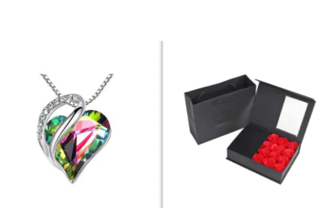 A set of a heart-shaped pendant necklace with a Rainbow crystal pendant surrounded by smaller clear crystal and a box.
