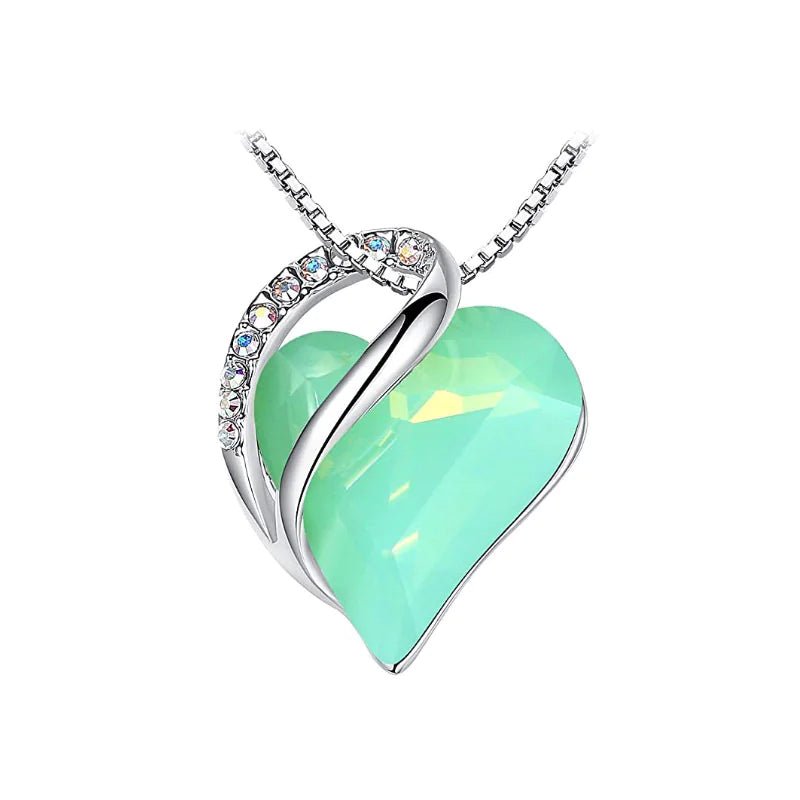 A heart-shaped pendant necklace with a Mint crystal pendant surrounded by smaller clear crystal.
