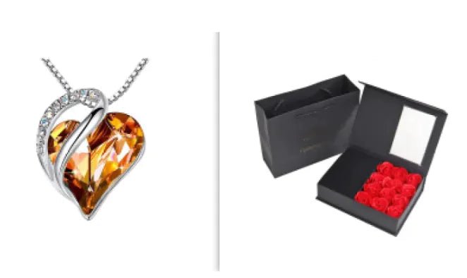A set of a heart-shaped pendant necklace with an Orange crystal pendant surrounded by smaller clear crystal and a box.