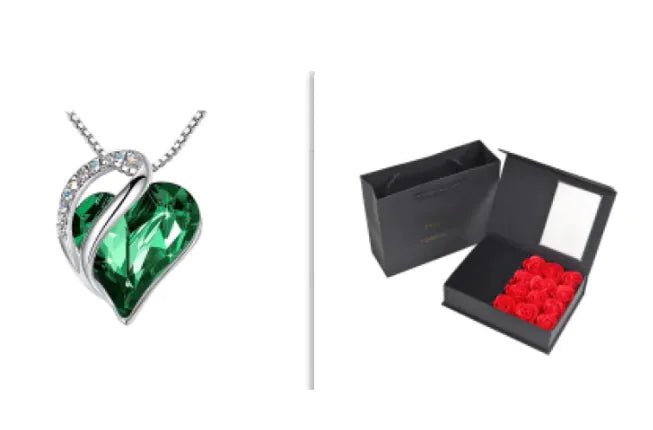 A set of a heart-shaped pendant necklace with a Dark Green crystal pendant surrounded by smaller clear crystal and a box.