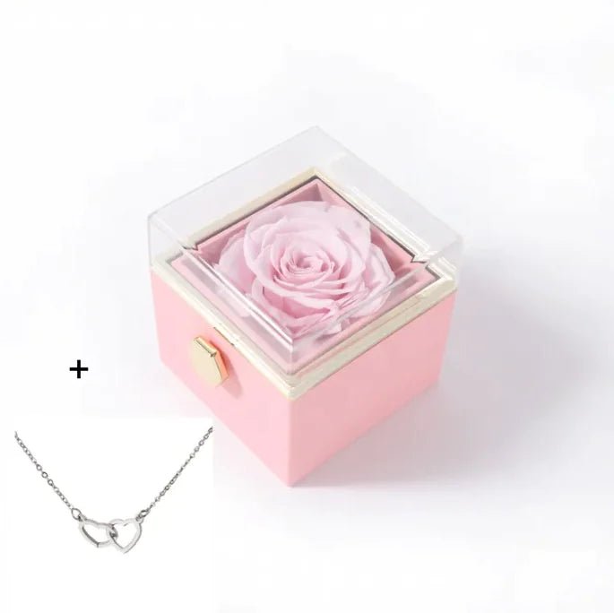 Pink rose in a box with a silver necklace