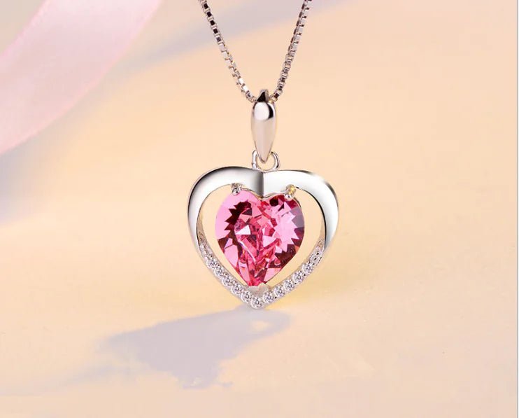 Pink Heart-shaped crystal pendant necklace on a silver chain.