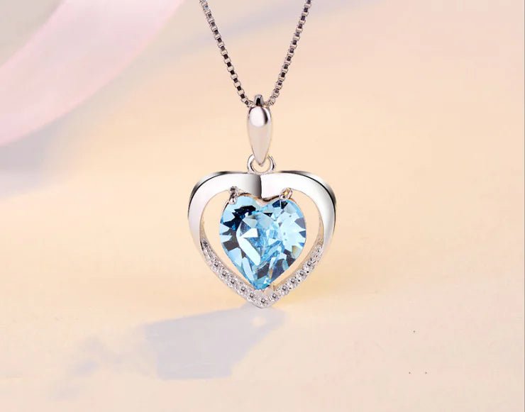 Blue Heart-shaped crystal pendant necklace on a silver chain.