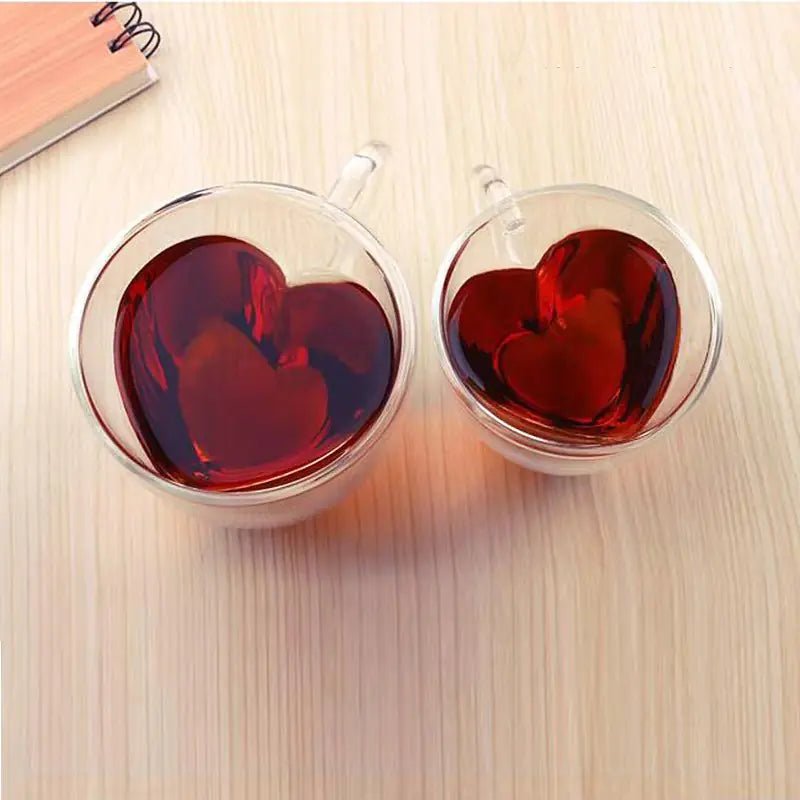 Two clear glass mugs with heart-shaped interiors