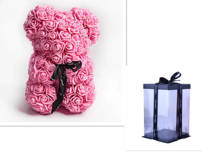A teddy bear made from Dark pink artificial roses, with a black ribbon bow, comes with a box