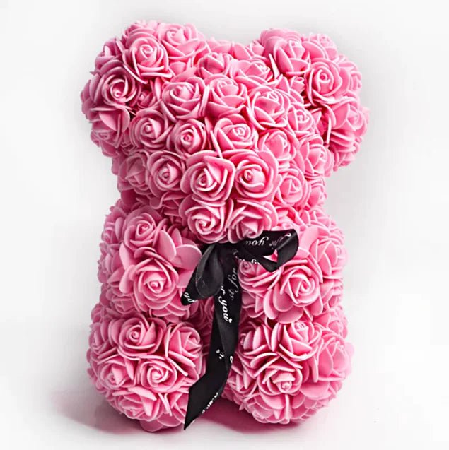 A teddy bear made from Dark pink artificial roses, with a black ribbon bow.