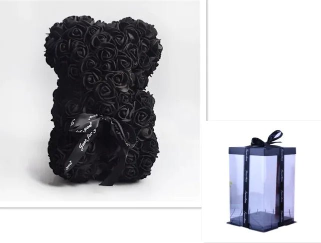 A teddy bear made from Black artifical roses, with a black ribbon bow, comes with a box.