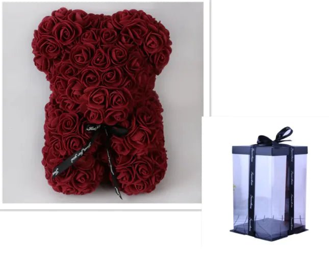 A teddy bear made from Wine Red artifical roses, with a black ribbon bow, comes with a box.