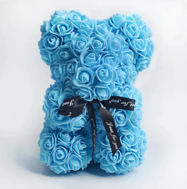 A teddy bear made from Sky blue artificial roses, with a black ribbon bow.