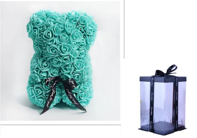 A teddy bear made from Turquoise artificial roses, with a black ribbon bow, comes with a box, comes with a box.