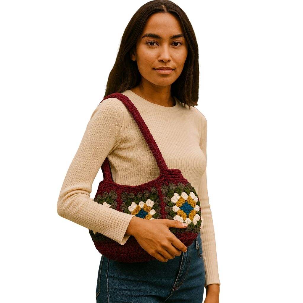 woman holding a crocheted bag with a geometric pattern with Wine Red straps