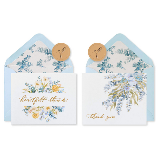 A set of eucalyptus thank you cards with matching envelopes and gold seals, featuring a floral design and the words 'thank you' on the front.