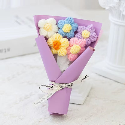 Bouquet of colorful crocheted flowers wrapped in purple paper 