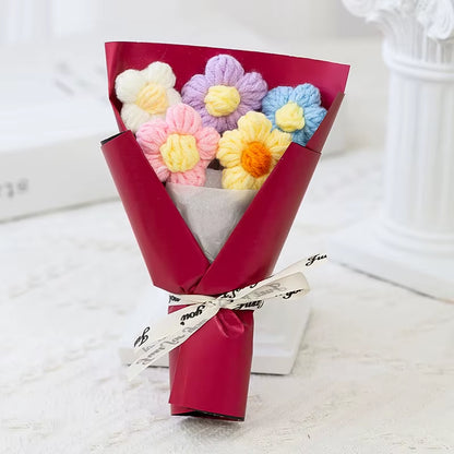 Bouquet of colorful knitted flowers in a red wrap with a decorative.