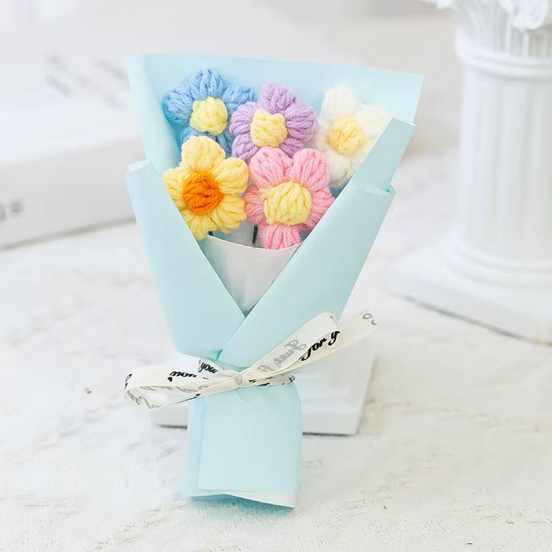 Bouquet of colorful yarn flowers in a light blue paper wrap