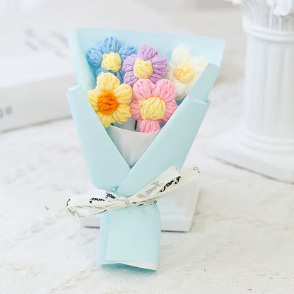 Bouquet of colorful yarn flowers in a light blue paper wrap