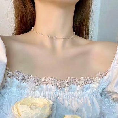 Close-up of a person wearing a delicate necklace