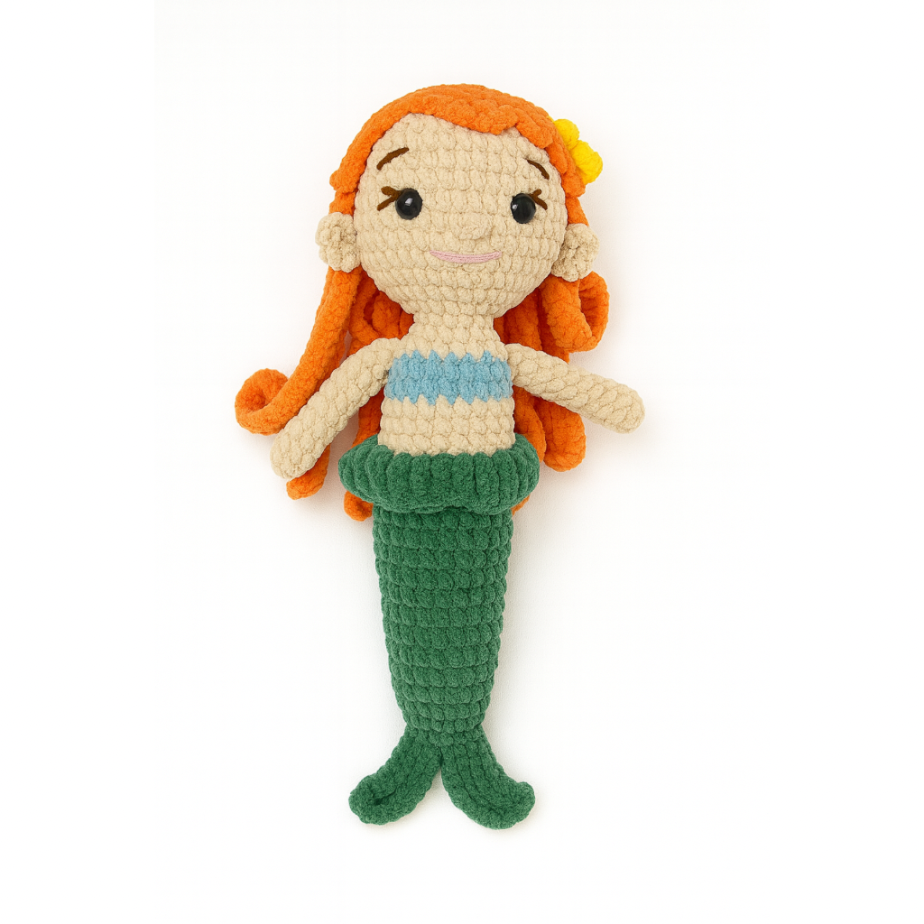 Crocheted Marina the mermaid toy with orange hair, blue top, and green tail