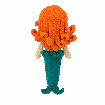 Crocheted Marina the mermaid toy with orange hair, blue top, and green tail