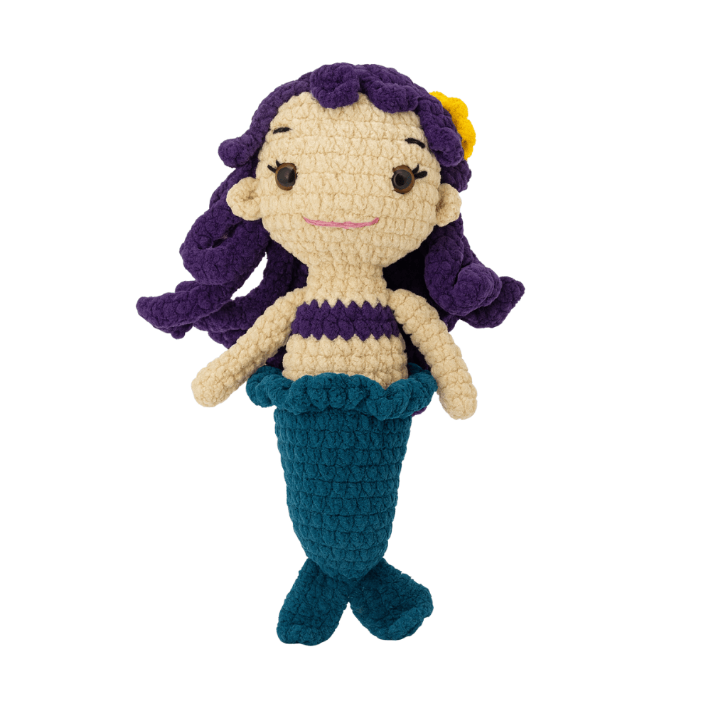 Crocheted Marina the mermaid toy with purple hair, purple top, and blue tail