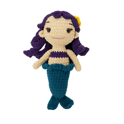 Crocheted Marina the mermaid toy with purple hair, purple top, and blue tail