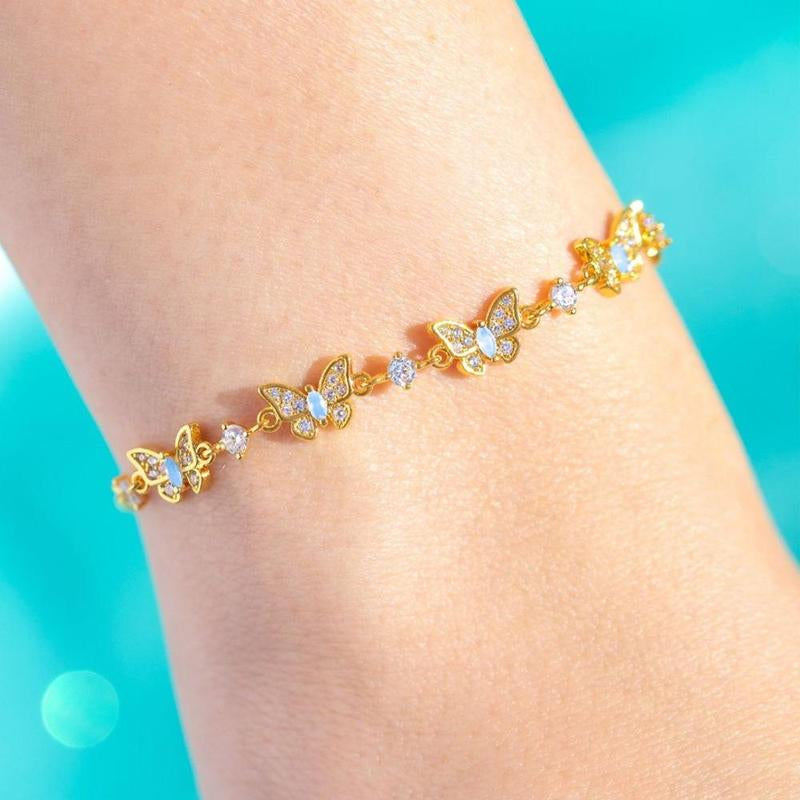 Gold butterfly bracelet on a wrist 