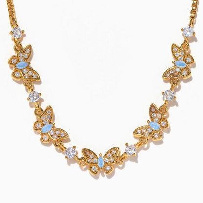 Gold butterfly necklace with blue accents 