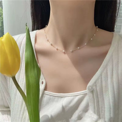 Necklace on a person with a yellow tulip 