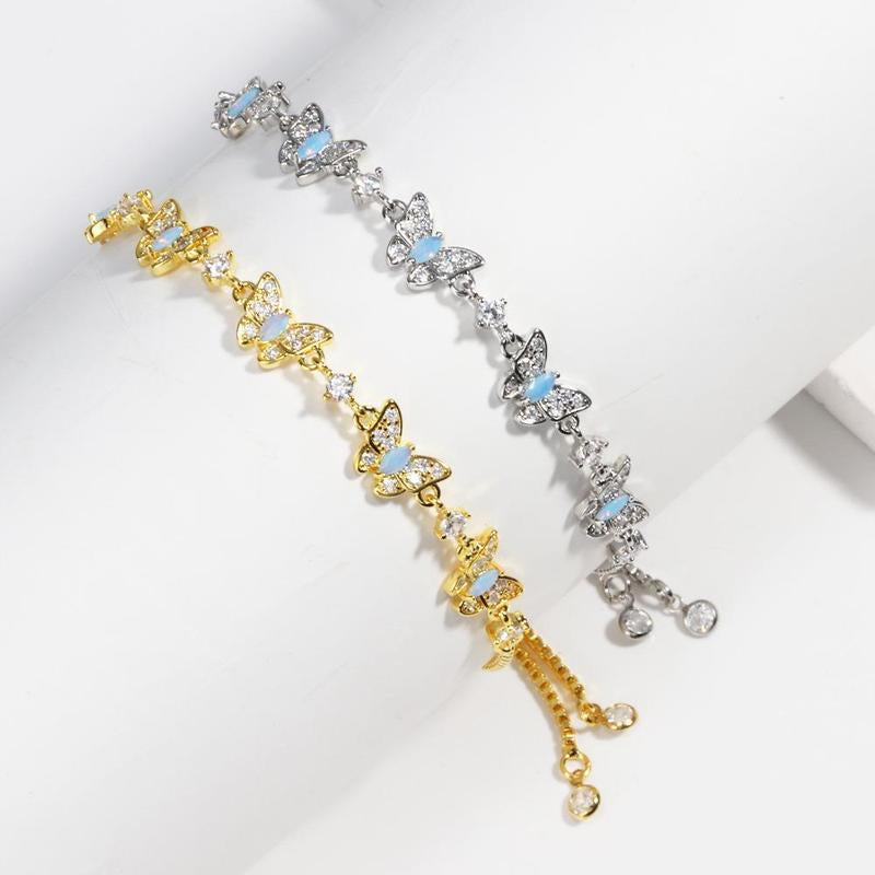 Two butterfly-shaped bracelets, one gold and one silver