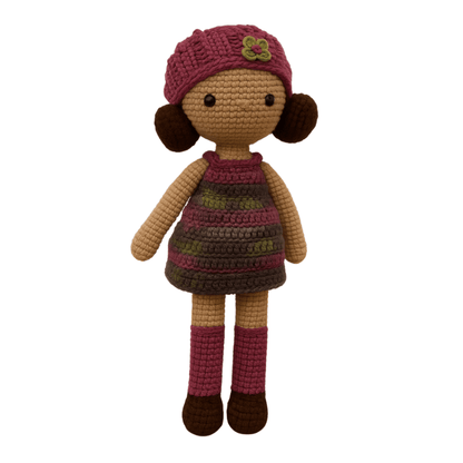 Handmade crochet doll with brown hair, wearing a purple striped dress and a matching beanie with a flower detail
