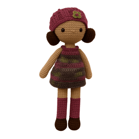 Handmade crochet doll with brown hair, wearing a purple striped dress and a matching beanie with a flower detail