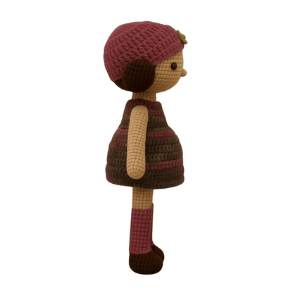 Handmade crochet doll with brown hair, wearing a purple striped dress and a matching beanie with a flower detail.