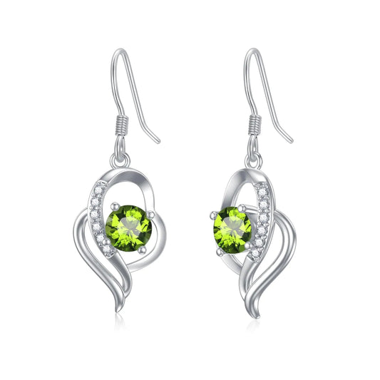 Silver earrings with green gemstones on a white background