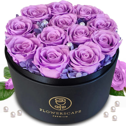 A matte black round gift box with 12 preserved purple roses arranged on top, accented with decorative pearls.