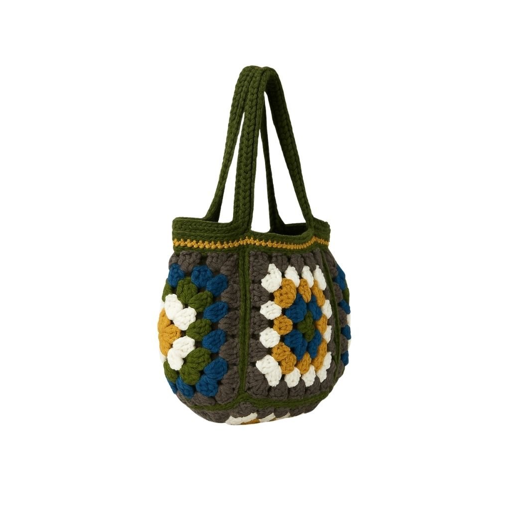 Crocheted bag with a geometric pattern with a green straps 