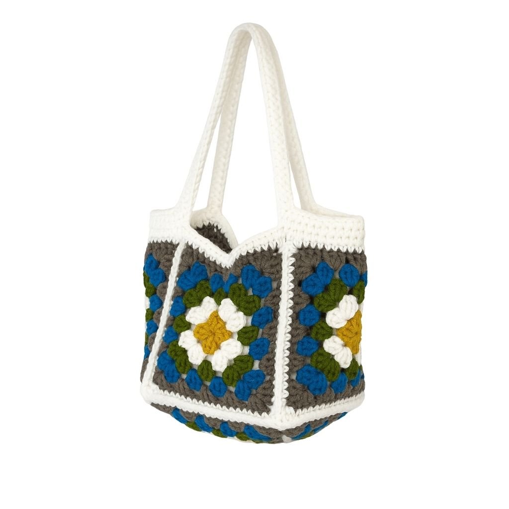Crocheted bag with a colorful square pattern with white straps 